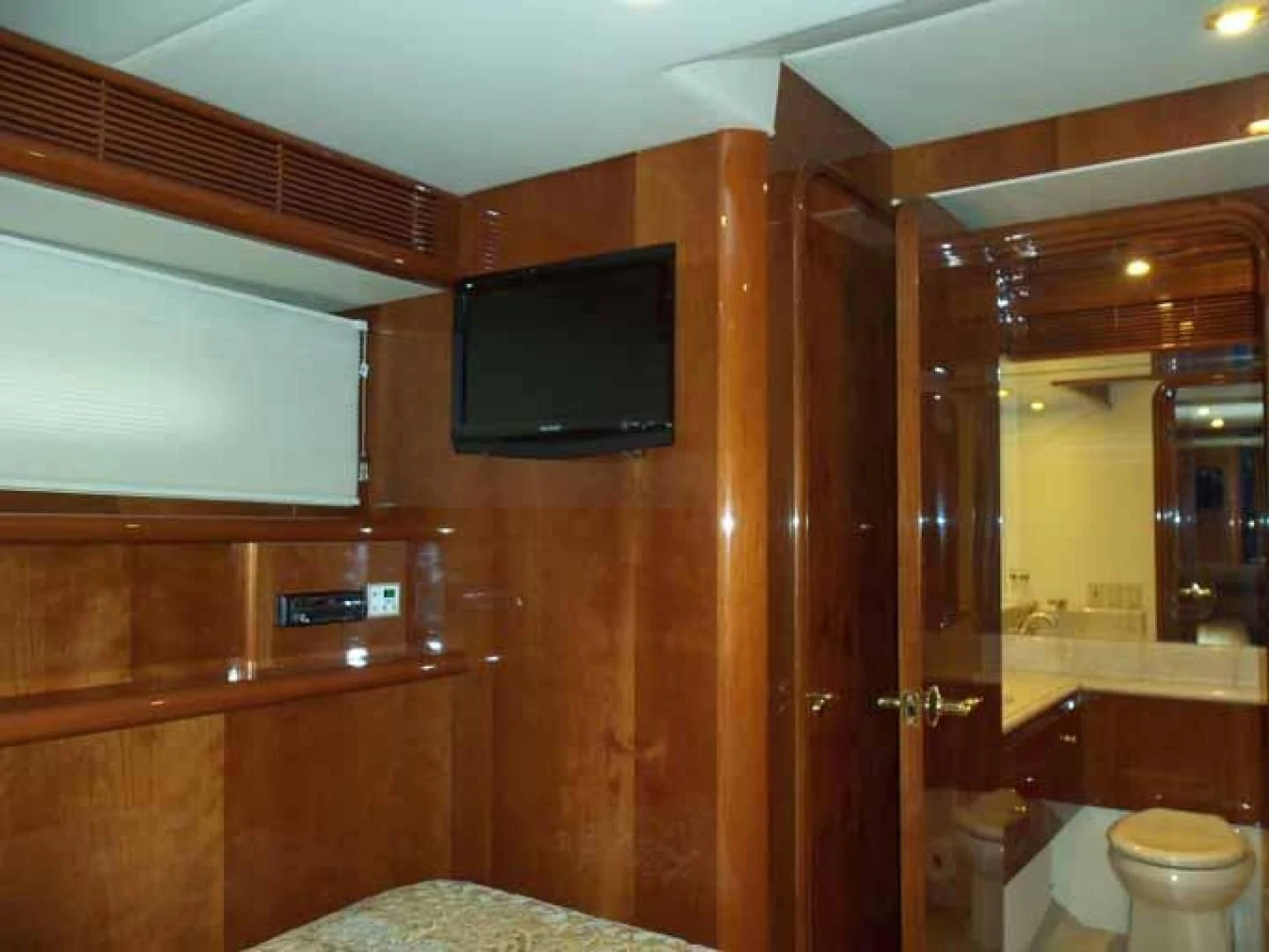 a bathroom with a television on the wall aboard DOLCE VITA Yacht for Sale