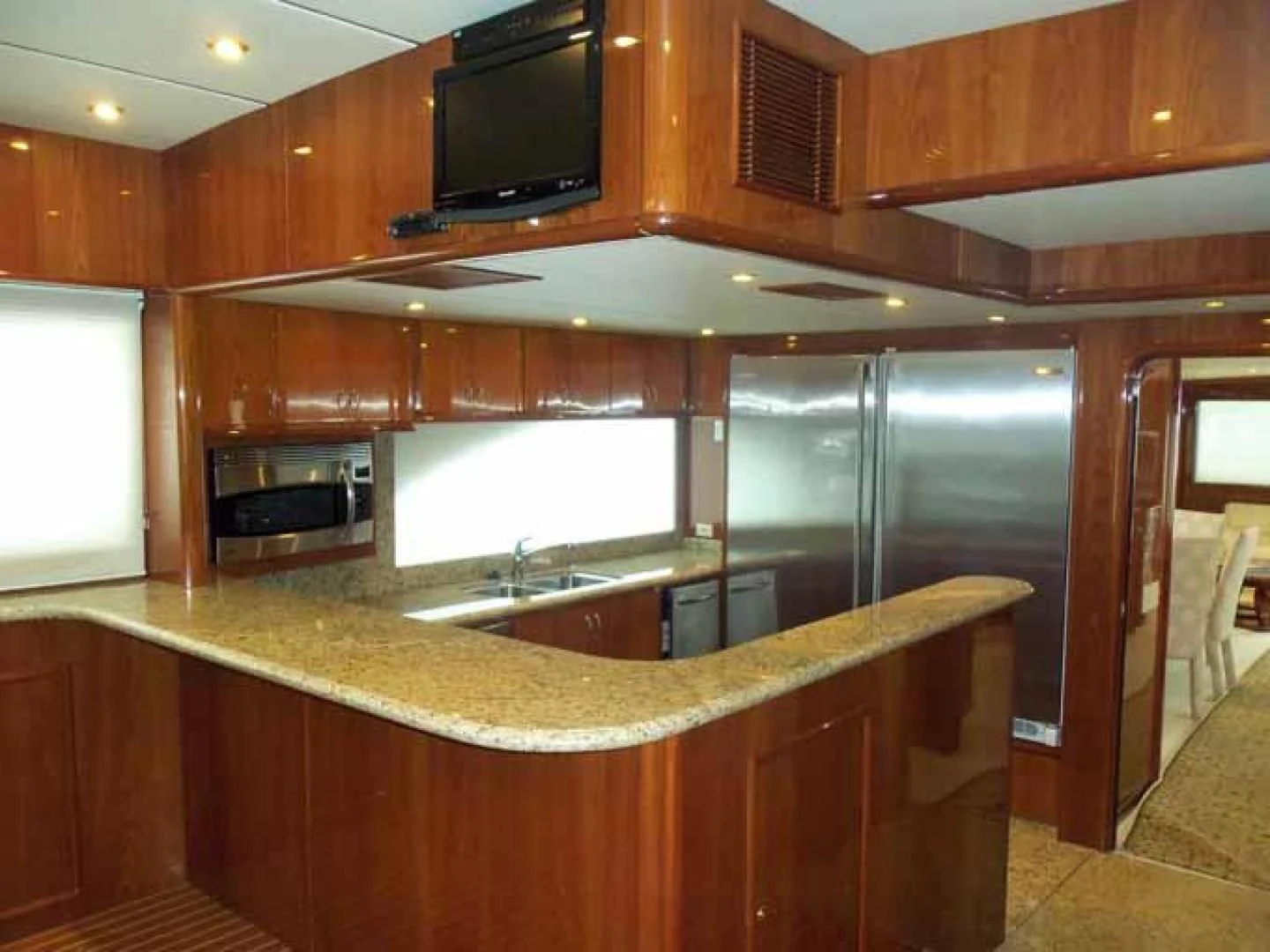 a kitchen with wooden cabinets aboard DOLCE VITA Yacht for Sale