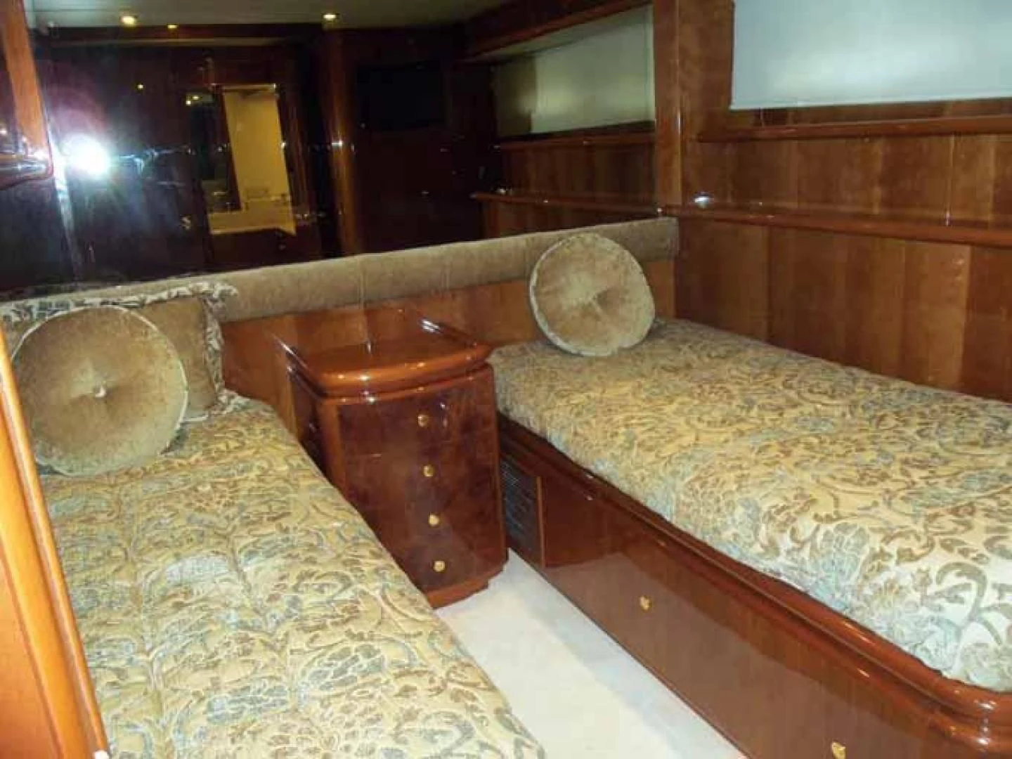 a room with a bed and a chair aboard DOLCE VITA Yacht for Sale