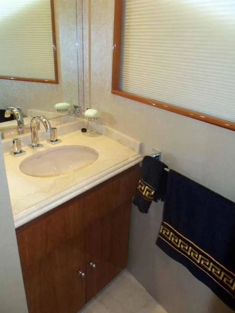 a bathroom with a sink and a towel on the wall aboard DOLCE VITA Yacht for Sale