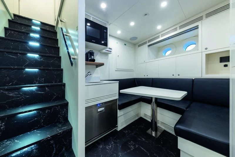 a room with a bed and desk aboard SEAESTA Yacht for Sale