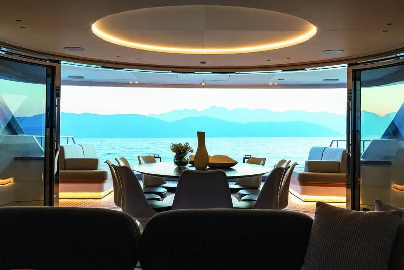 inside of a bus with a table and chairs and a vase on the table aboard SEAESTA Yacht for Sale