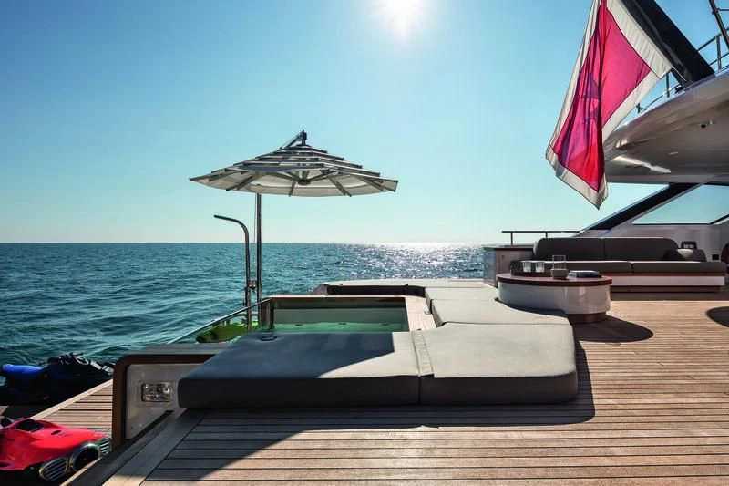 a boat on a deck with an umbrella and a flag aboard SEAESTA Yacht for Sale