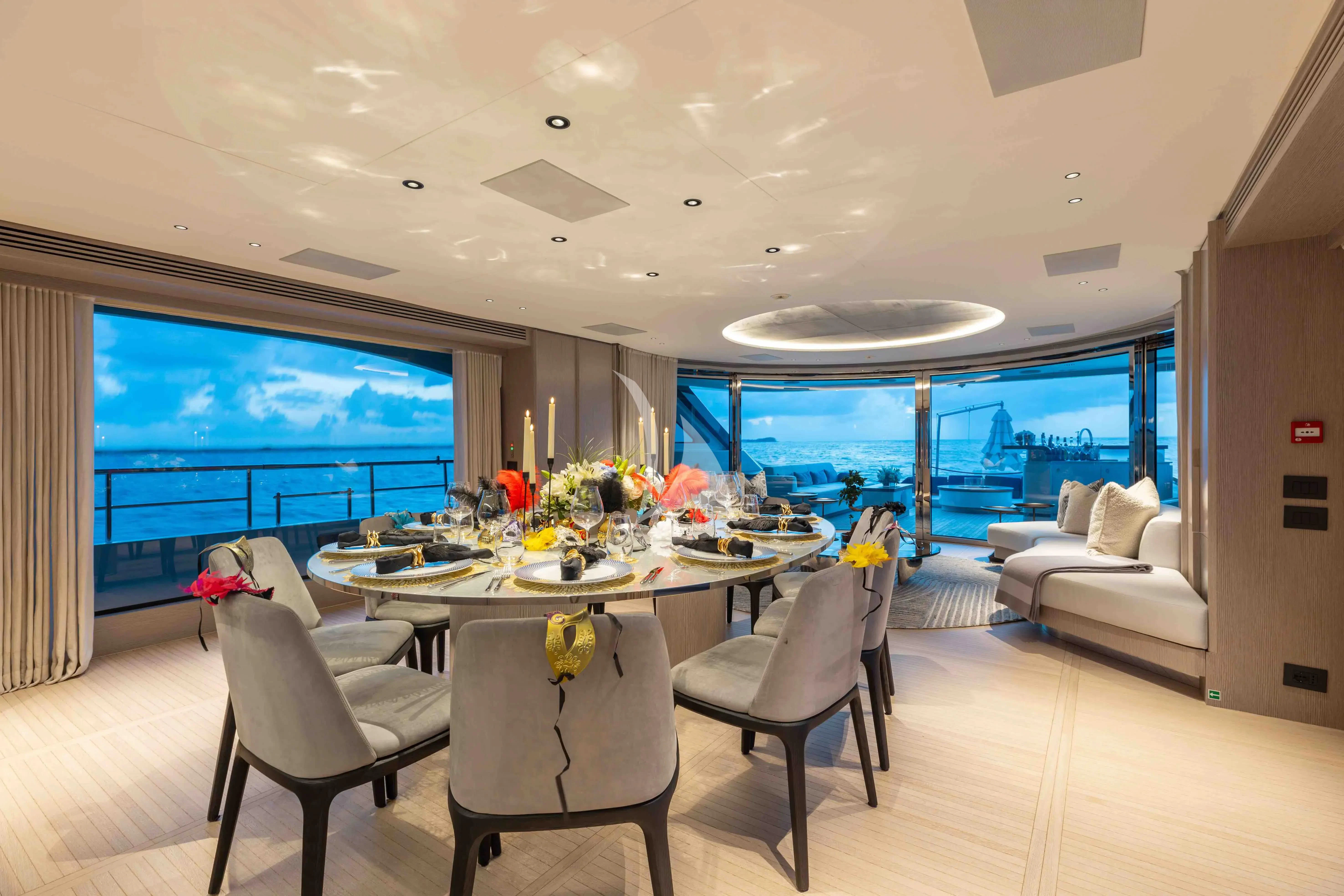 a large room with a table and chairs aboard SEAESTA Yacht for Sale