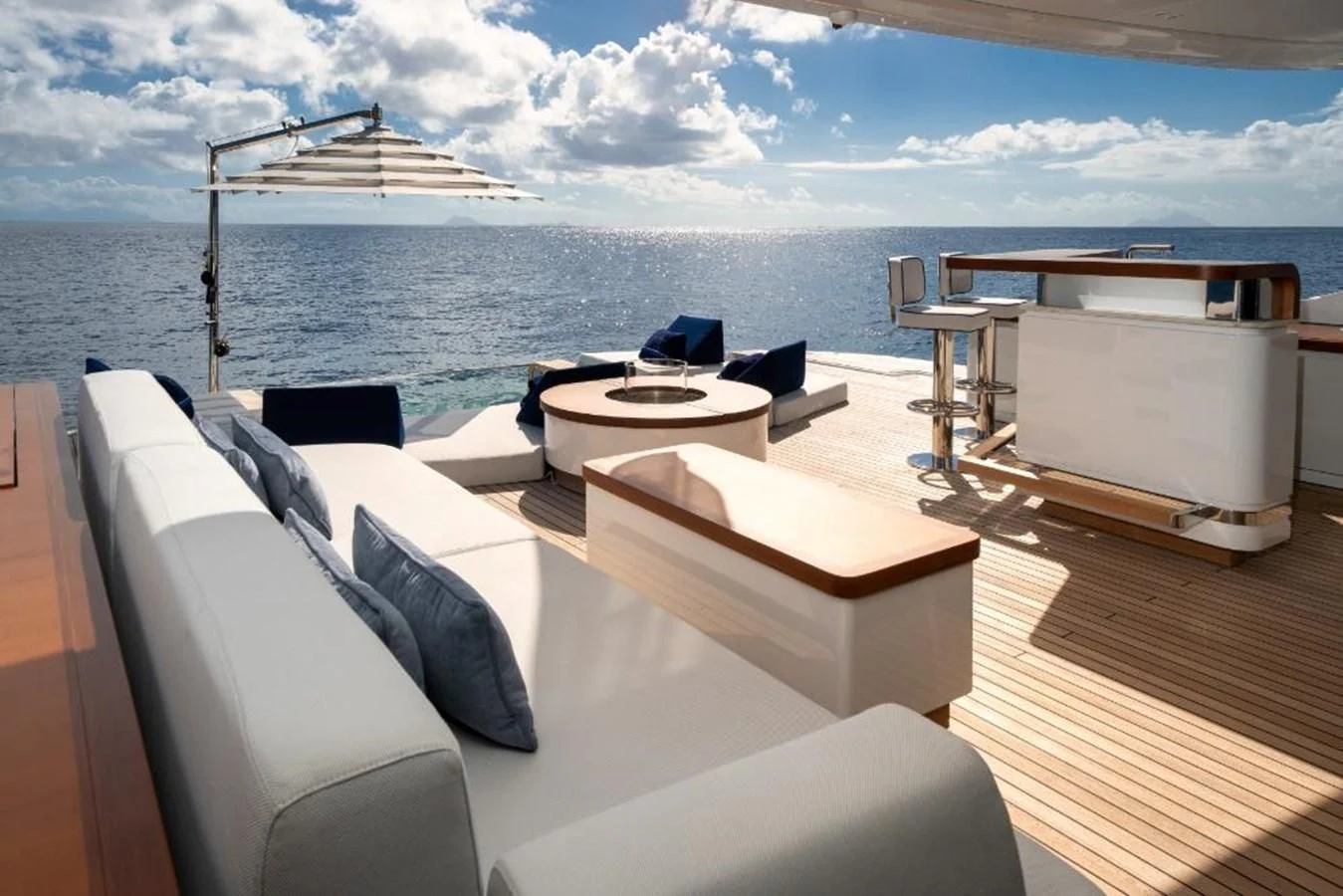 a room with a bed and a table on a boat in the water aboard SEAESTA Yacht for Sale