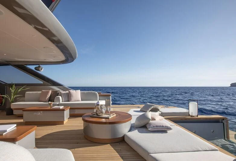 a room with a couch and a table and a large body of water aboard SEAESTA Yacht for Sale