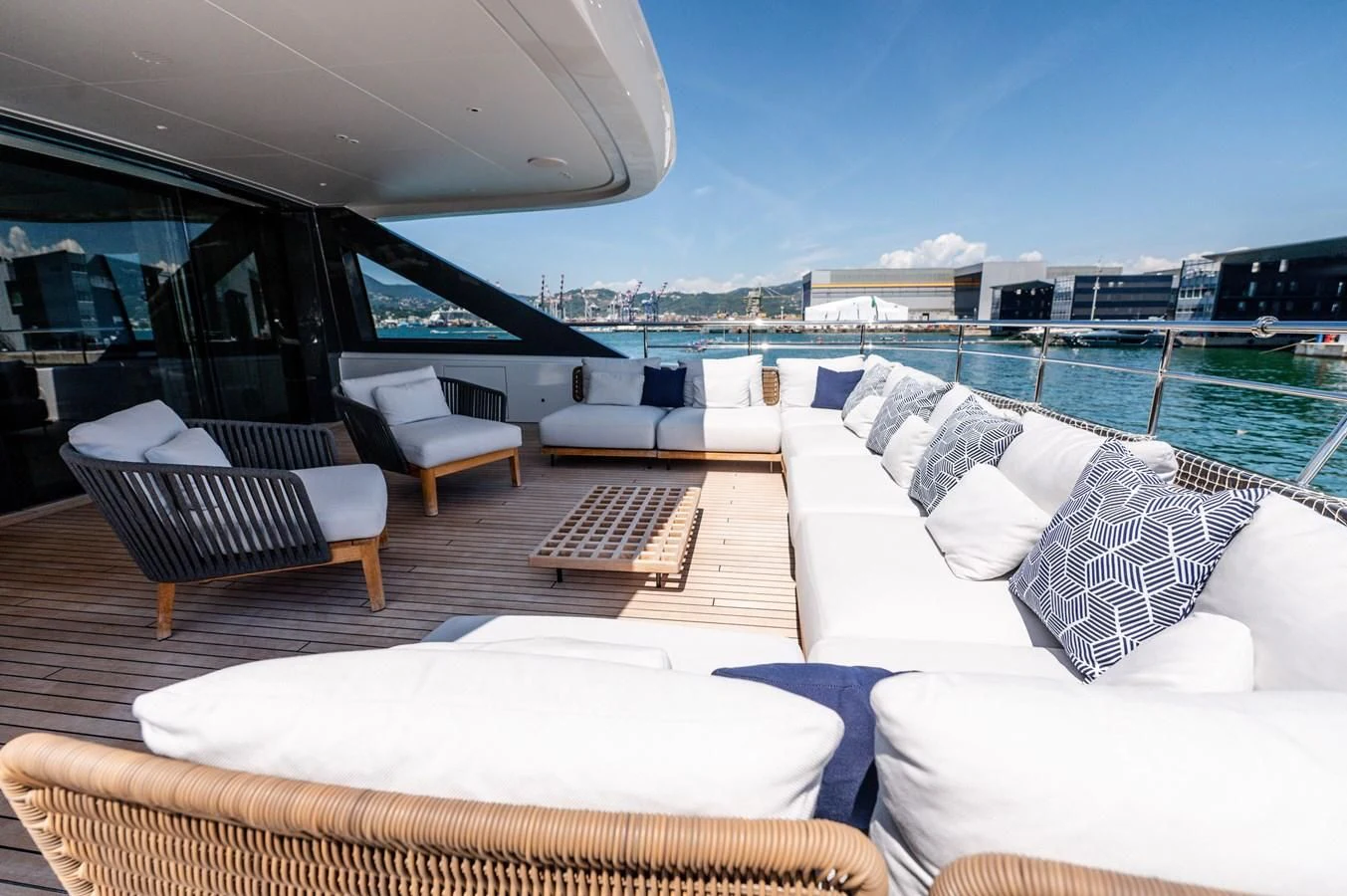 a room with a view of the ocean and a city aboard SEAESTA Yacht for Sale