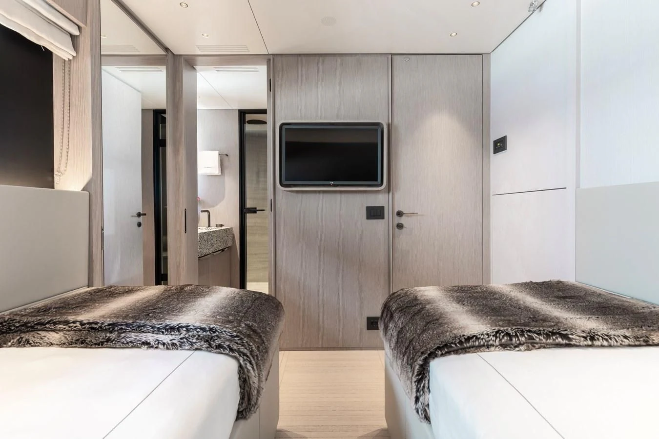 a bedroom with a tv and a bed aboard SEAESTA Yacht for Sale