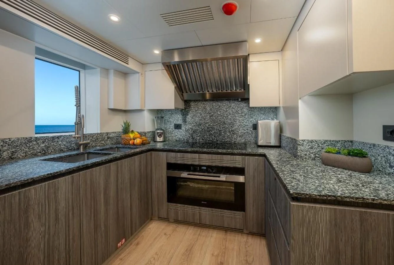 a kitchen with a stove and a microwave aboard SEAESTA Yacht for Sale