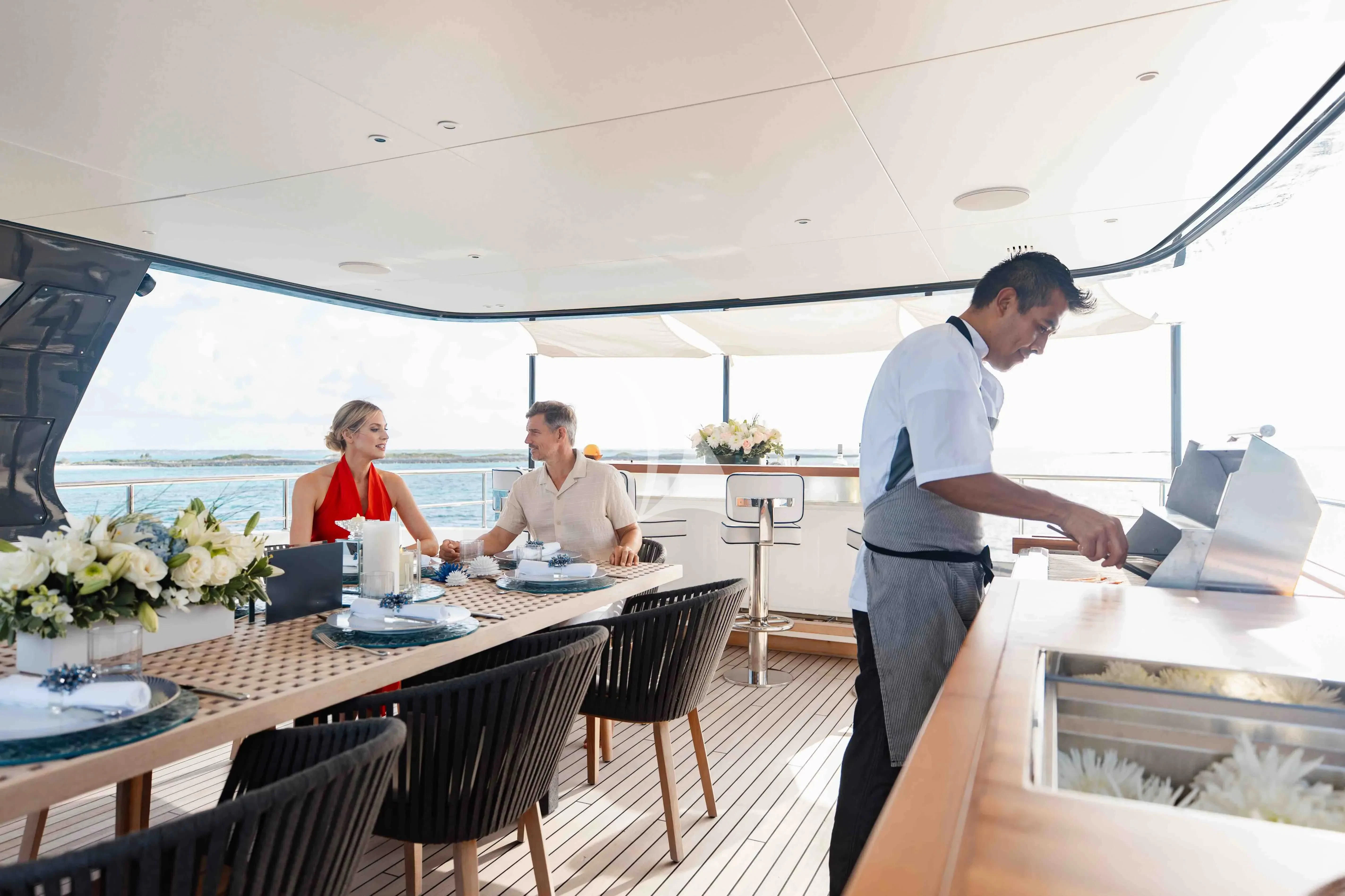 a group of people sitting at a table aboard SEAESTA Yacht for Sale