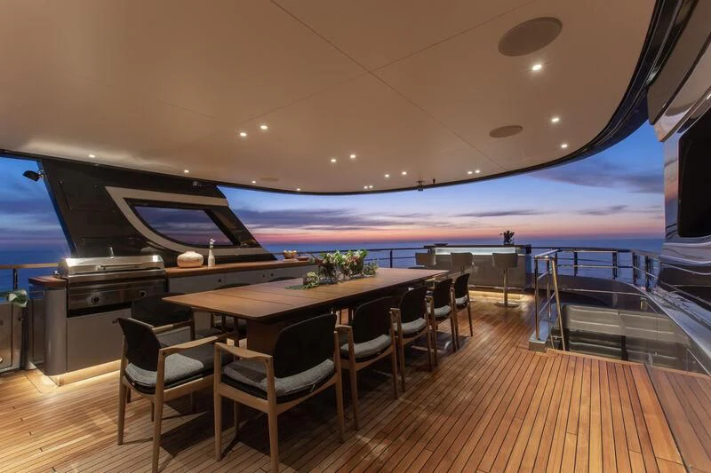 a large room with a table and chairs and a large body of water aboard SEAESTA Yacht for Sale