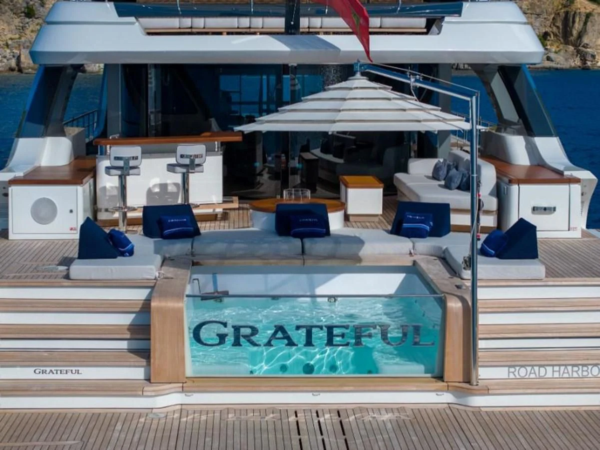 a swimming pool with a deck and chairs aboard SEAESTA Yacht for Sale