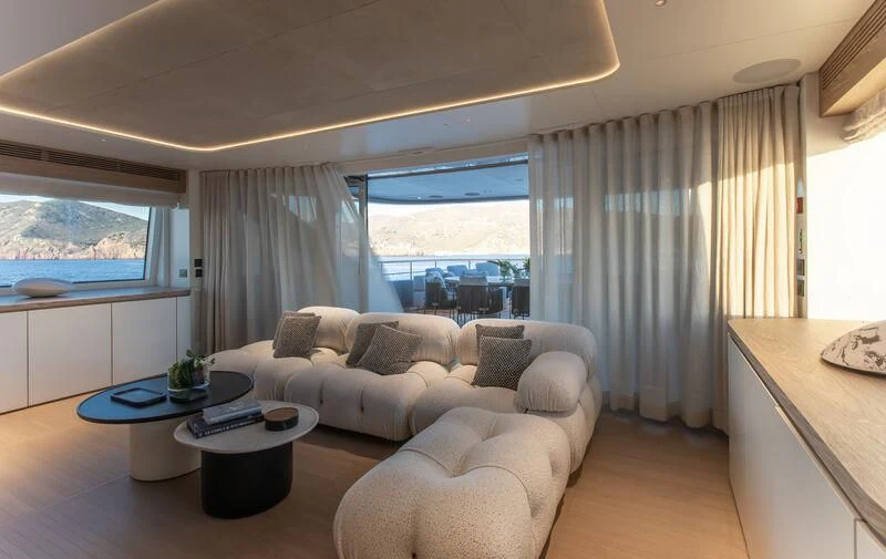 a living room with a couch and a table aboard SEAESTA Yacht for Sale