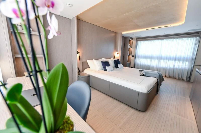 a room with a bed and a chair aboard SEAESTA Yacht for Sale
