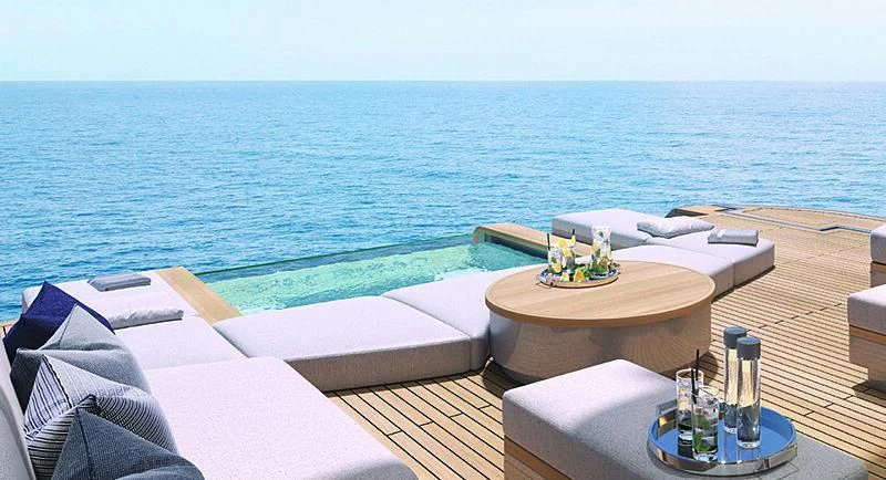 a table with candles on it by the ocean aboard SEAESTA Yacht for Sale