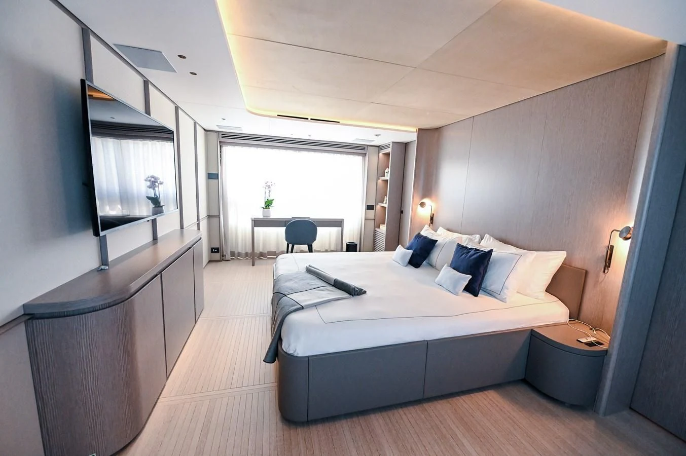 a bedroom with a bed and a table aboard SEAESTA Yacht for Sale