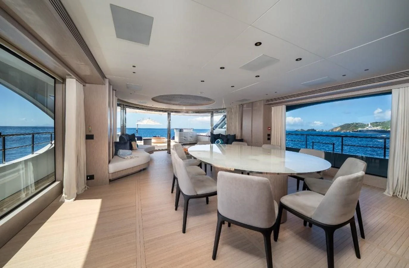 a large room with a table and chairs aboard SEAESTA Yacht for Sale
