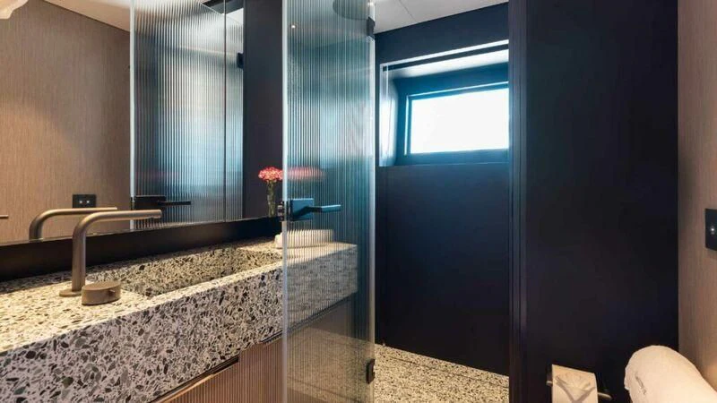 a bathroom with a countertop sink and a shower aboard SEAESTA Yacht for Sale