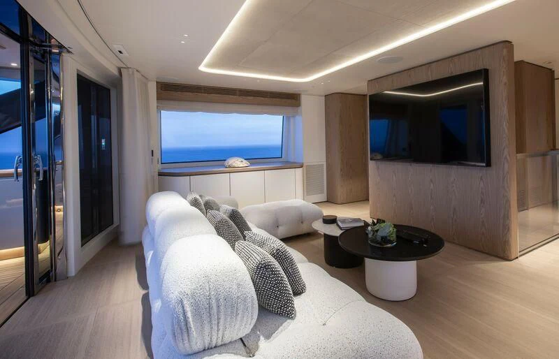 a living room with a large window aboard SEAESTA Yacht for Sale