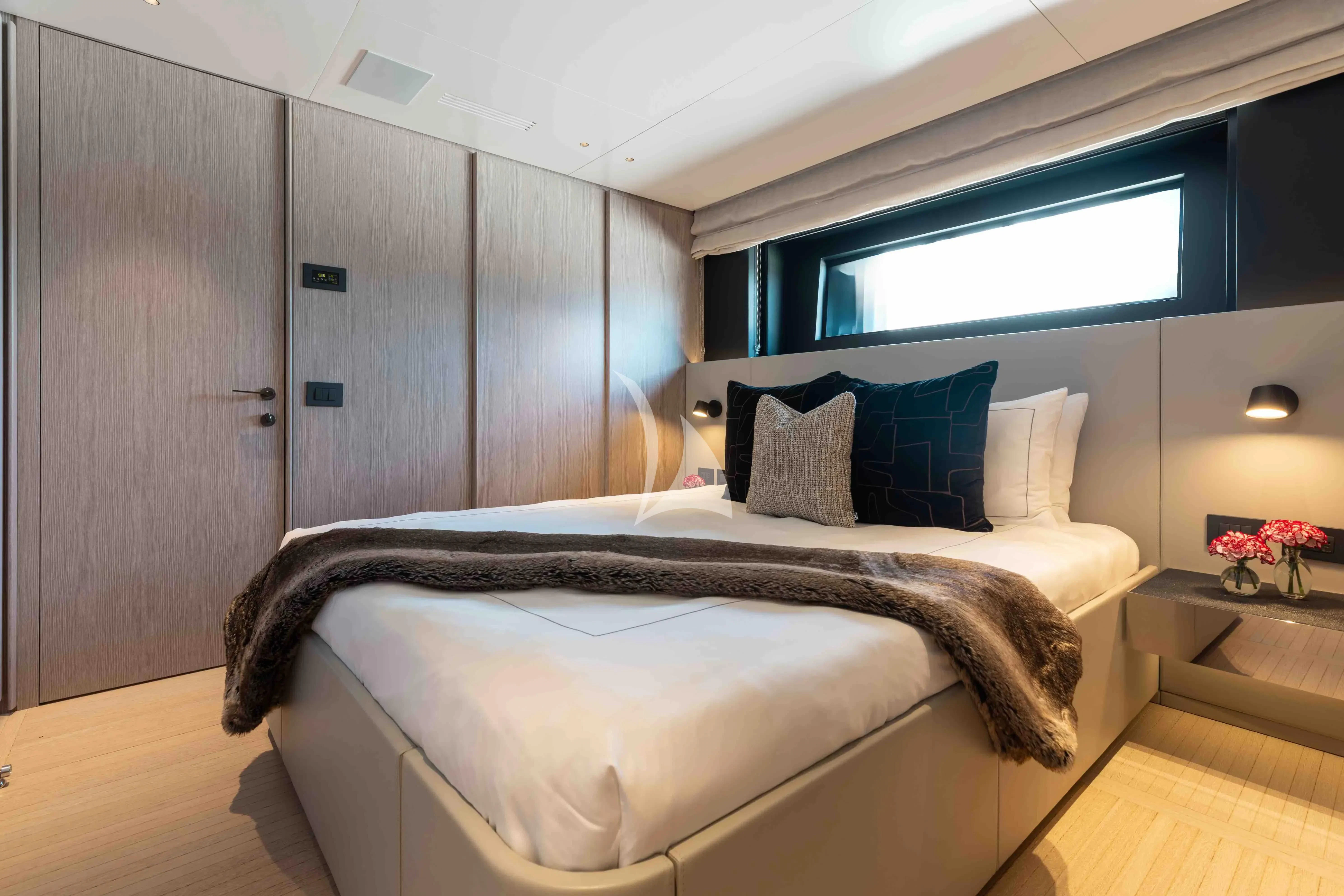 a bed with a black and white bed spread aboard SEAESTA Yacht for Sale