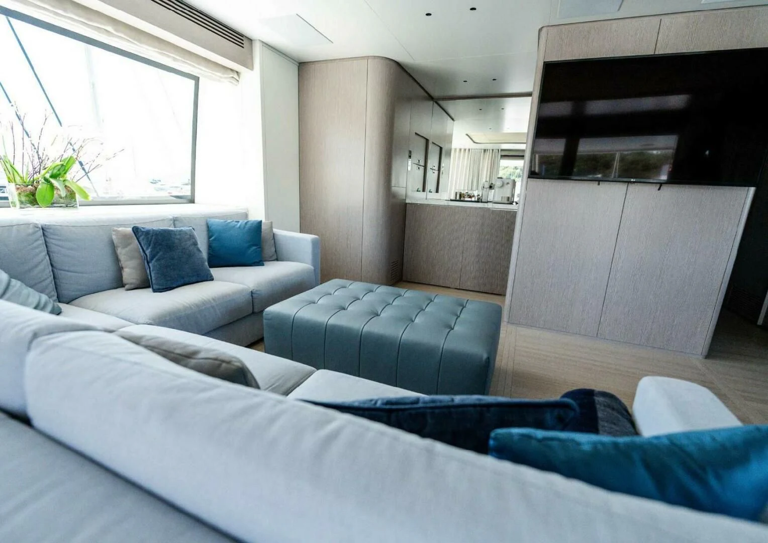 a living room with a couch and a tv aboard SEAESTA Yacht for Sale