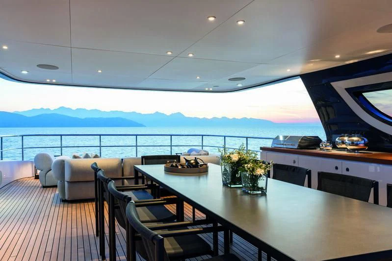 a room with a table chairs and a view of the ocean aboard SEAESTA Yacht for Sale