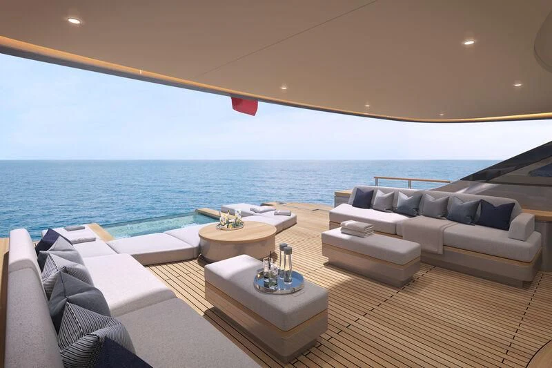 a room with a couch and a table and a large body of water aboard SEAESTA Yacht for Sale