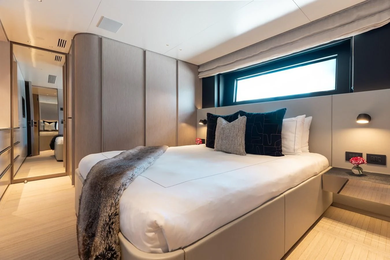 a bedroom with a bed and a window aboard SEAESTA Yacht for Sale