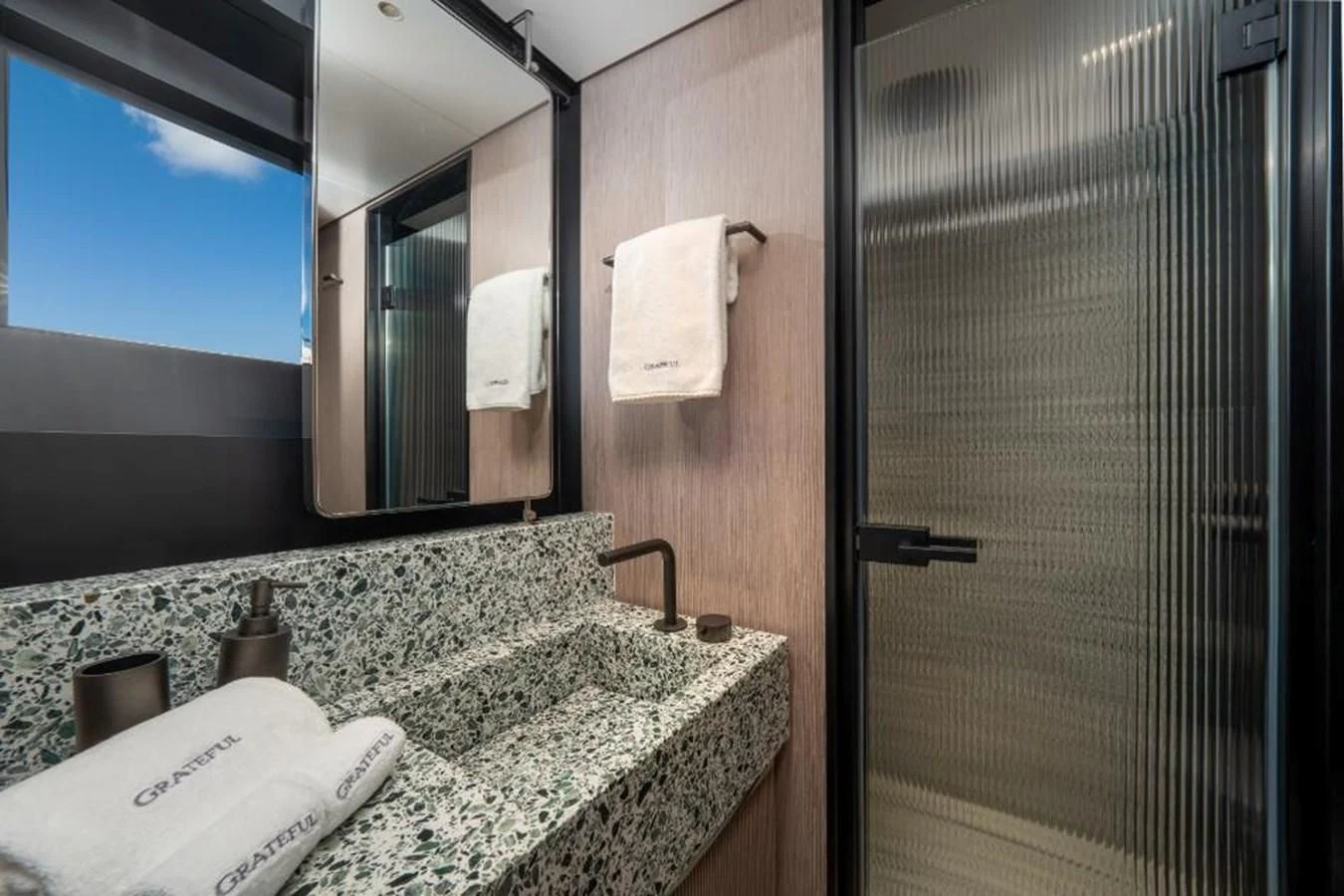 a bathroom with a countertop sink and mirror aboard SEAESTA Yacht for Sale