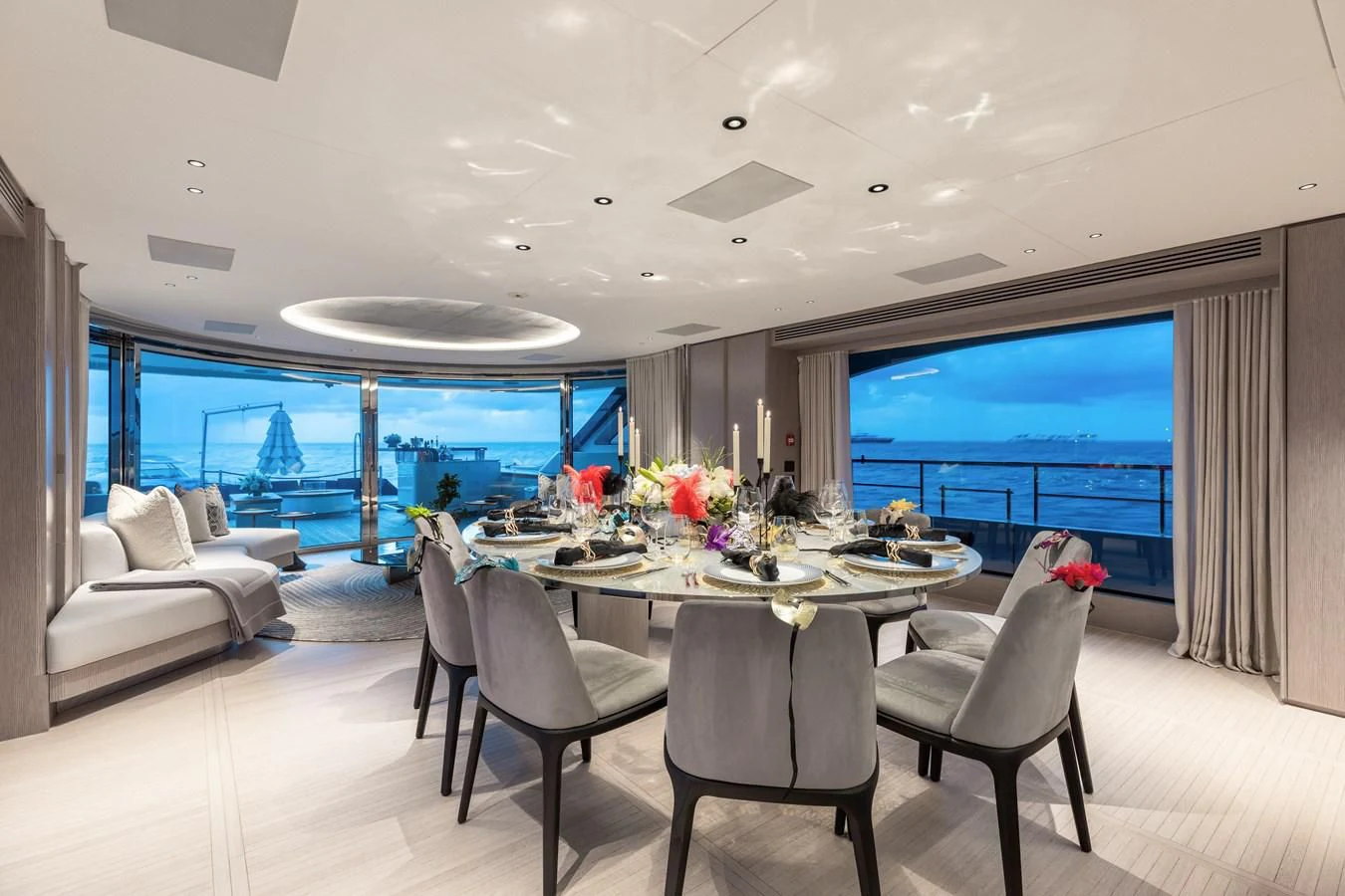 a large room with a table and chairs aboard SEAESTA Yacht for Sale