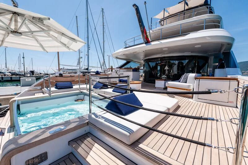 a boat with a deck and a deck with a deck and chairs aboard SEAESTA Yacht for Sale