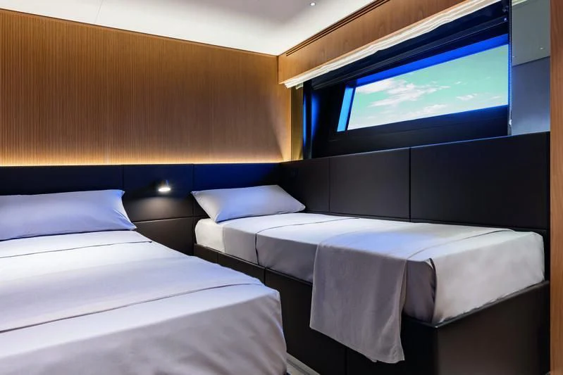 a room with beds and a tv aboard SEAESTA Yacht for Sale