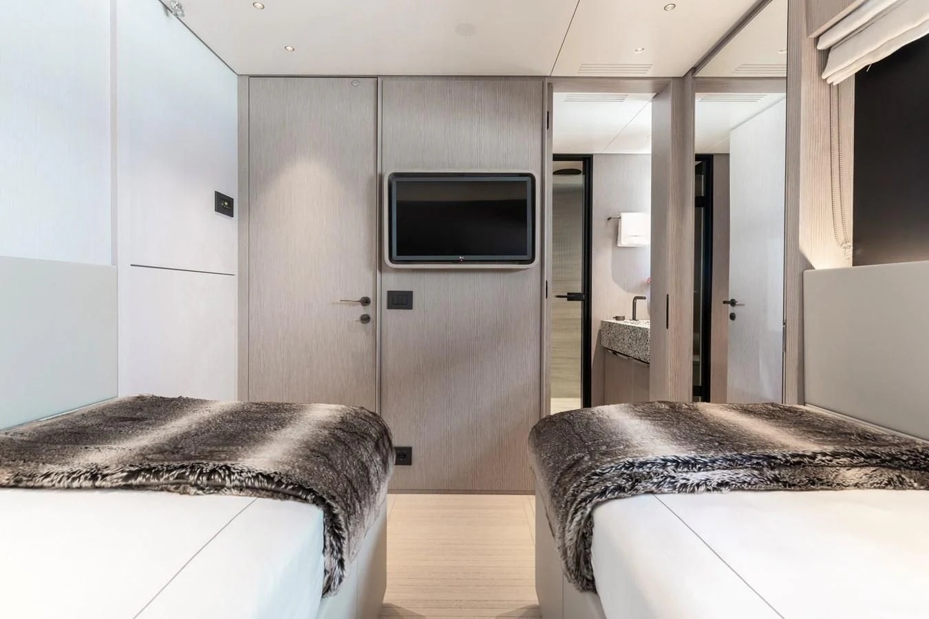 a bedroom with a tv and a bed aboard SEAESTA Yacht for Sale