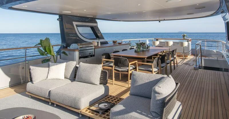 a large living room with a large balcony overlooking the ocean aboard SEAESTA Yacht for Sale