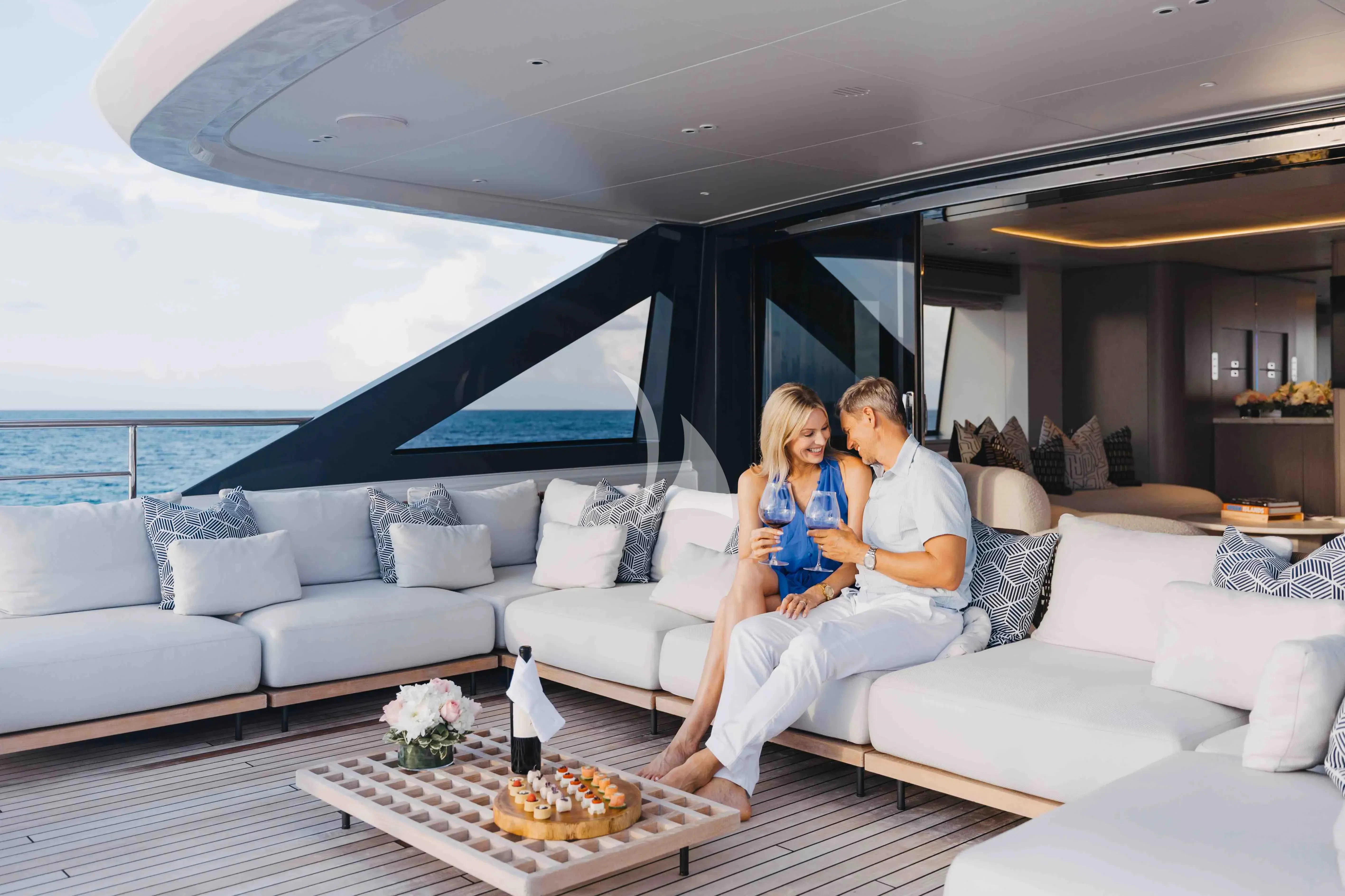 a man and woman sitting on a couch with a baby aboard SEAESTA Yacht for Sale