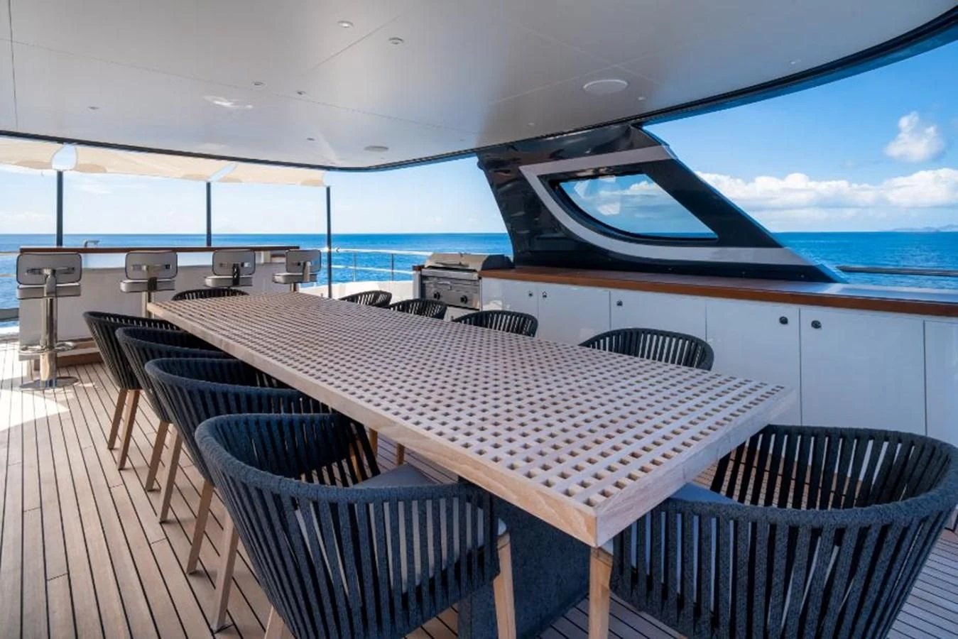 a deck with a table and chairs aboard SEAESTA Yacht for Sale