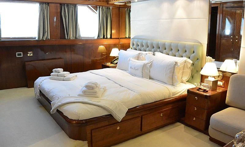 a bed with white sheets aboard WHITE KNIGHT Yacht for Sale