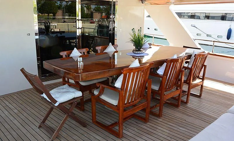 a table with chairs on it aboard WHITE KNIGHT Yacht for Sale
