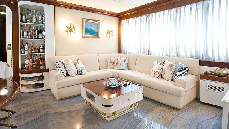a living room with a couch and a coffee table aboard ATHINA Yacht for Sale