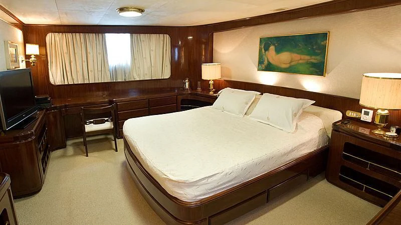 a hotel room with a bed and a television aboard ATHINA Yacht for Sale