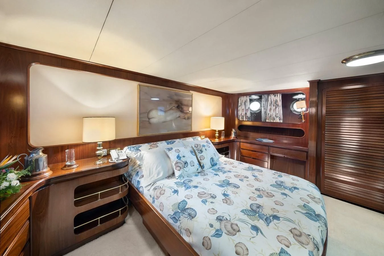 a bedroom with a bed and a desk aboard ATHINA Yacht for Sale