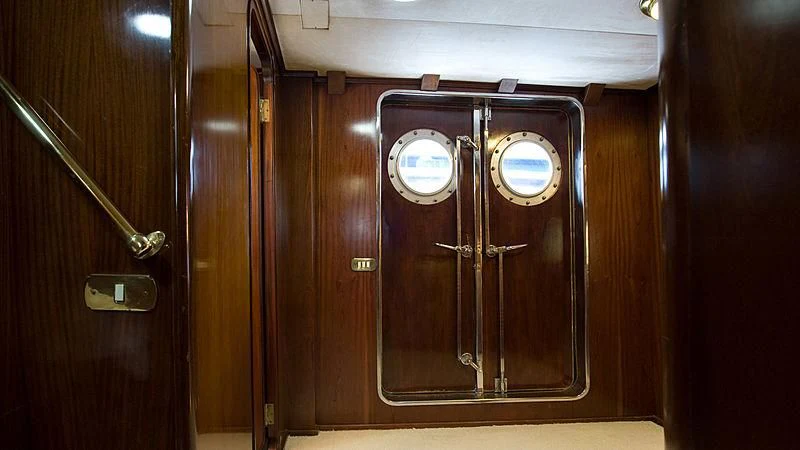 a wooden cabinet with a door aboard ATHINA Yacht for Sale