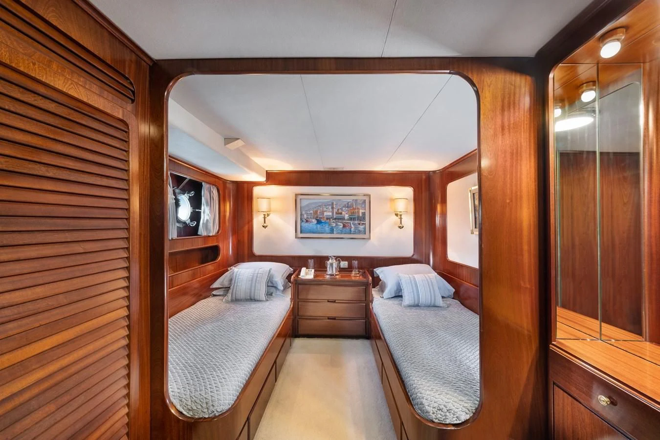 a room with a bed and a mirror aboard ATHINA Yacht for Sale