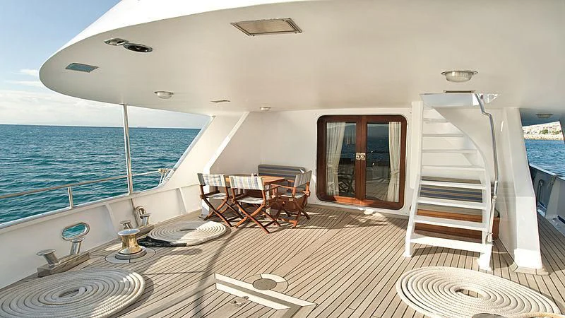 a room with a deck and a pool aboard ATHINA Yacht for Sale