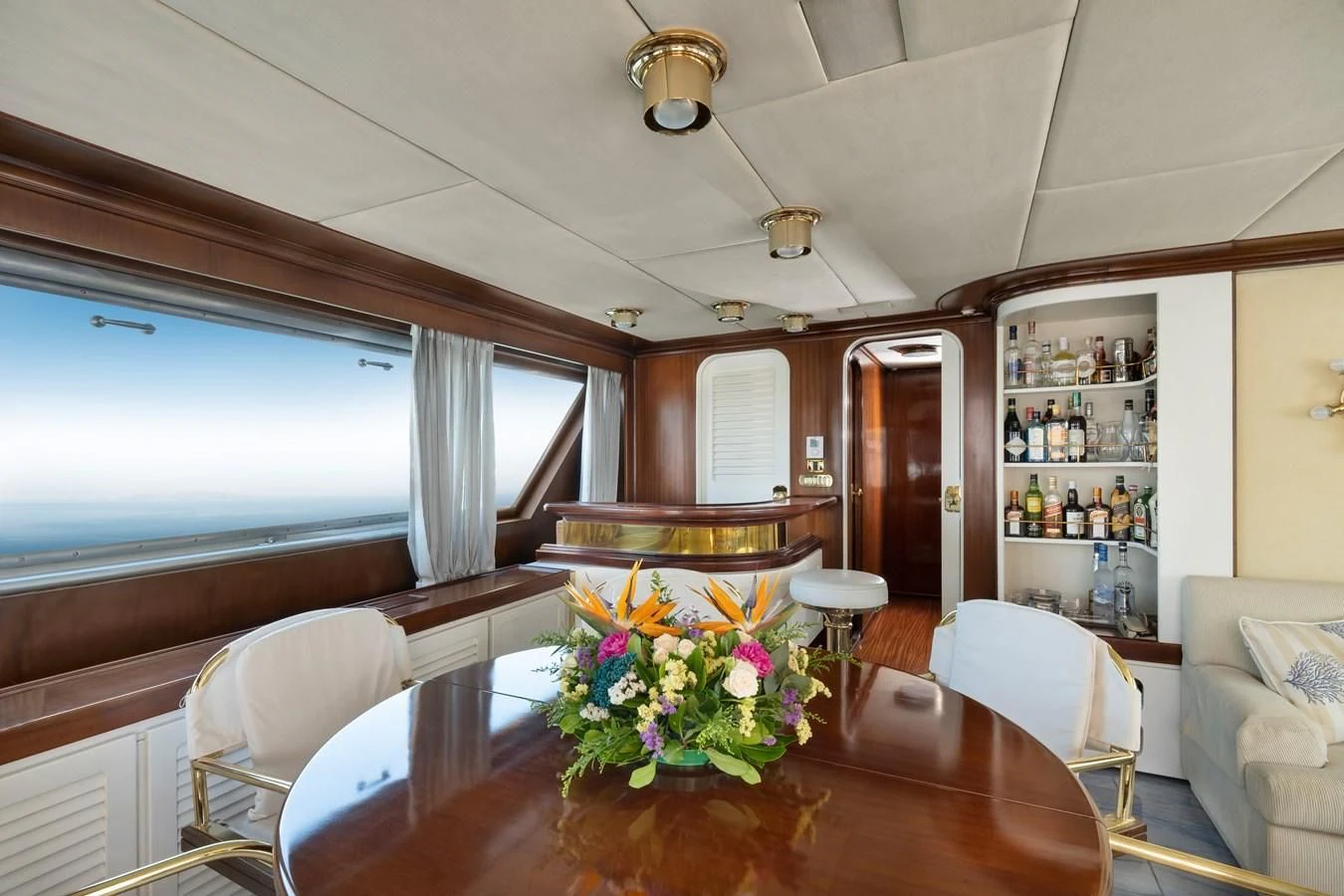 a dining table in a living room aboard ATHINA Yacht for Sale
