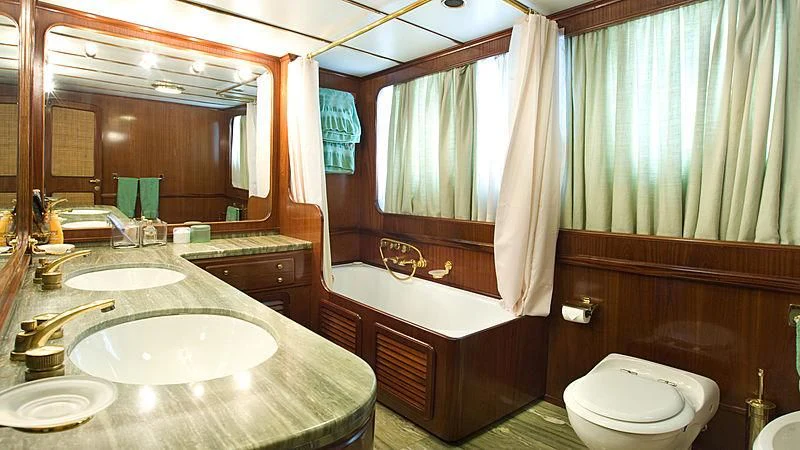 a bathroom with a tub sink and toilet aboard ATHINA Yacht for Sale