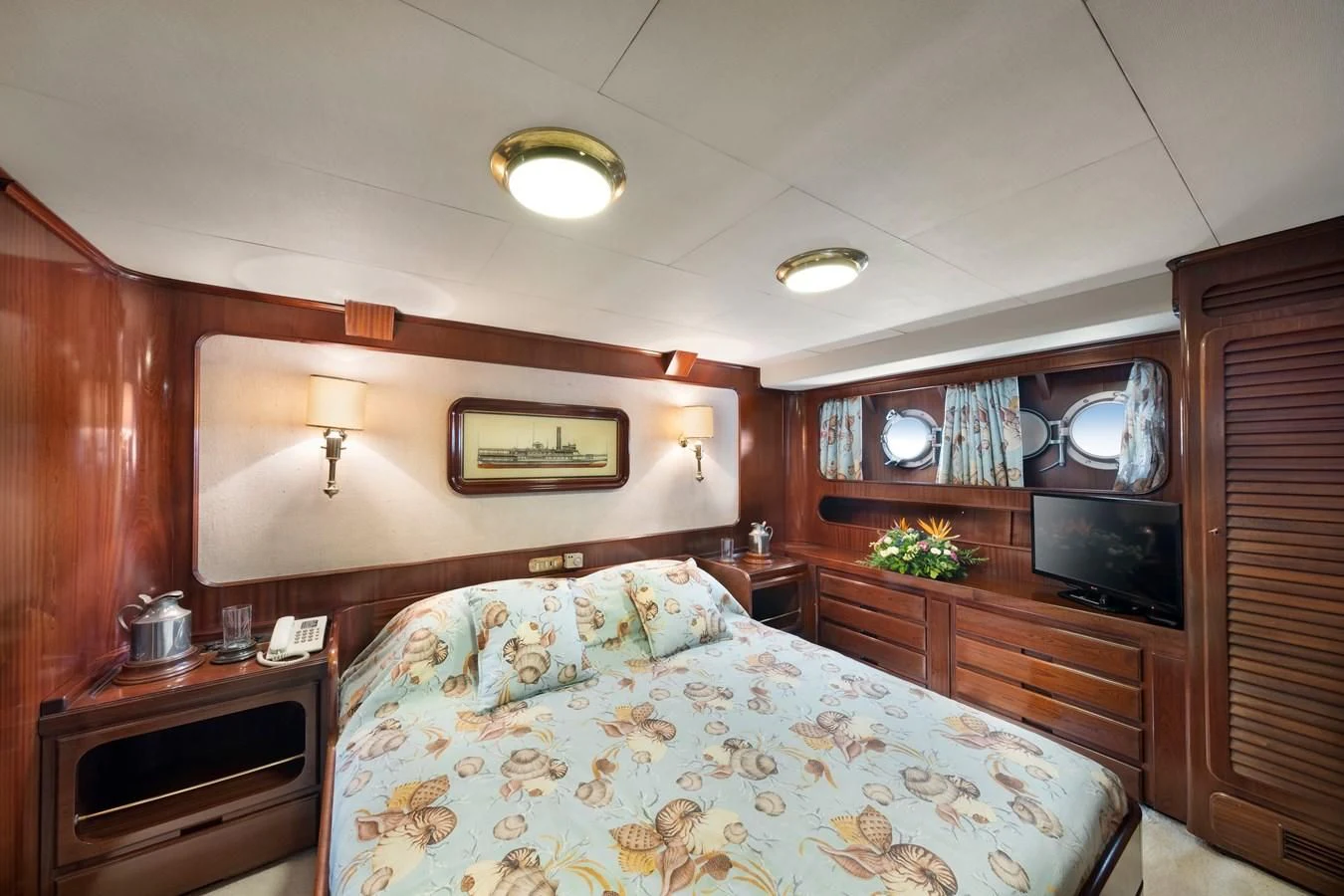 a bedroom with a bed and a television aboard ATHINA Yacht for Sale