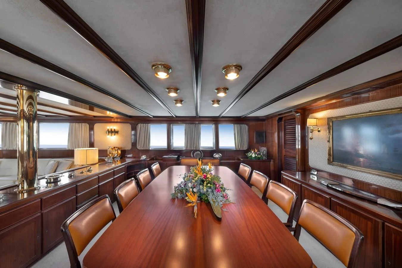 a large room with a large table and chairs aboard ATHINA Yacht for Sale