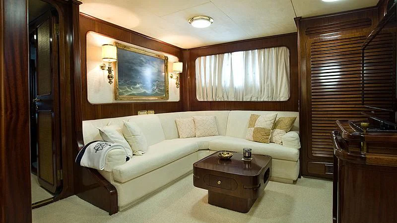 a living room with a couch and a coffee table aboard ATHINA Yacht for Sale