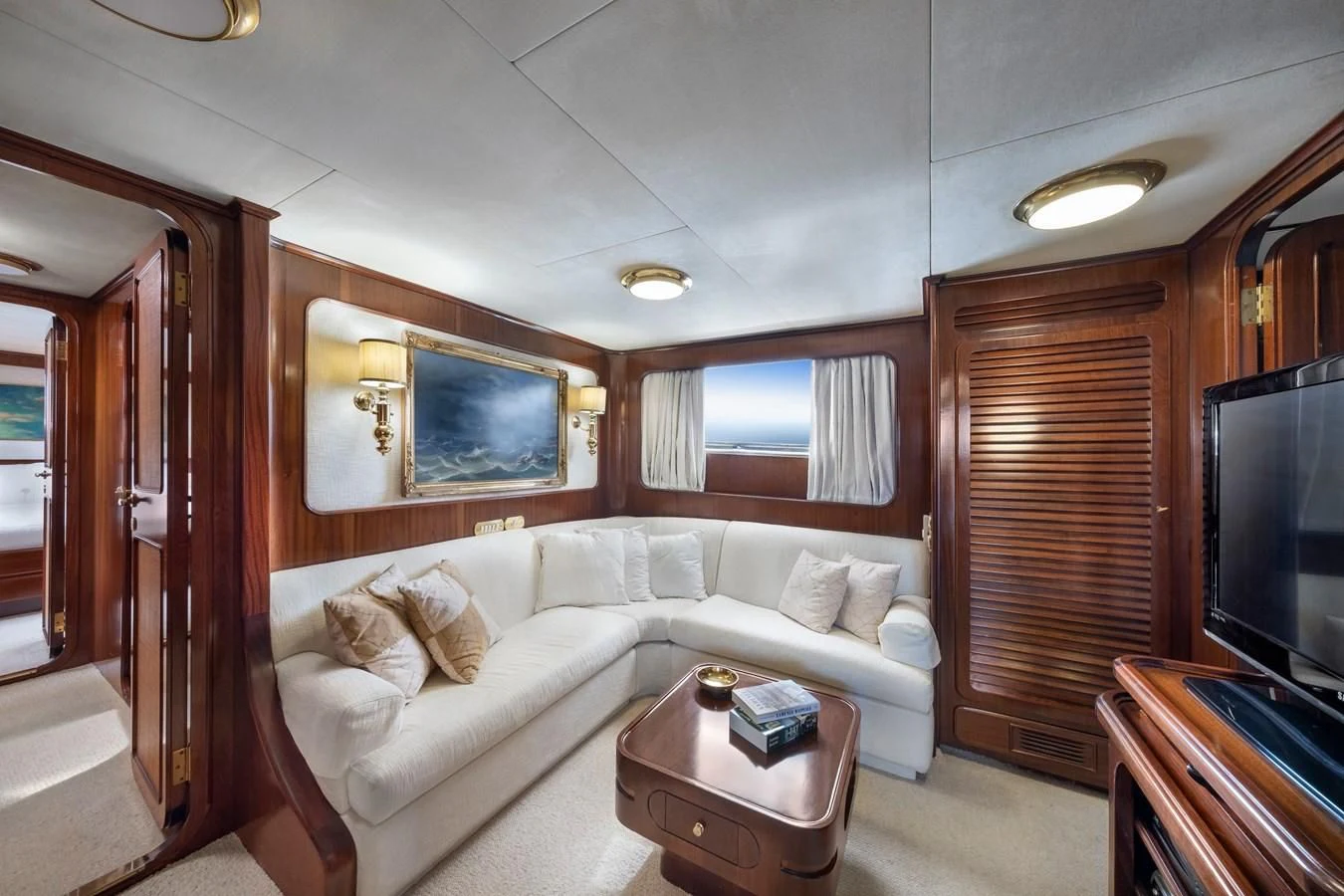 a living room with a couch and a television aboard ATHINA Yacht for Sale